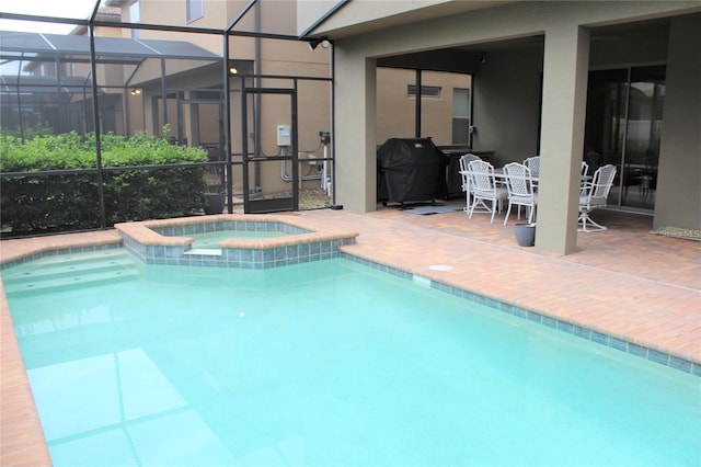 view of pool featuring an in ground hot tub, a patio, area for grilling, and a lanai