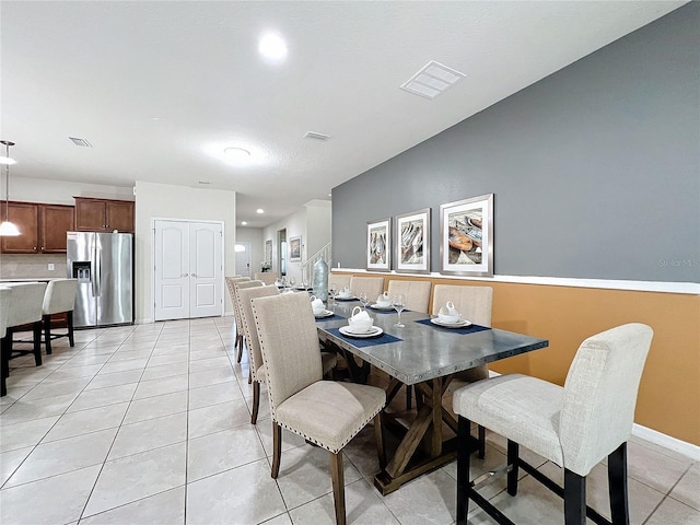 dining area featuring light tile patterned flooring