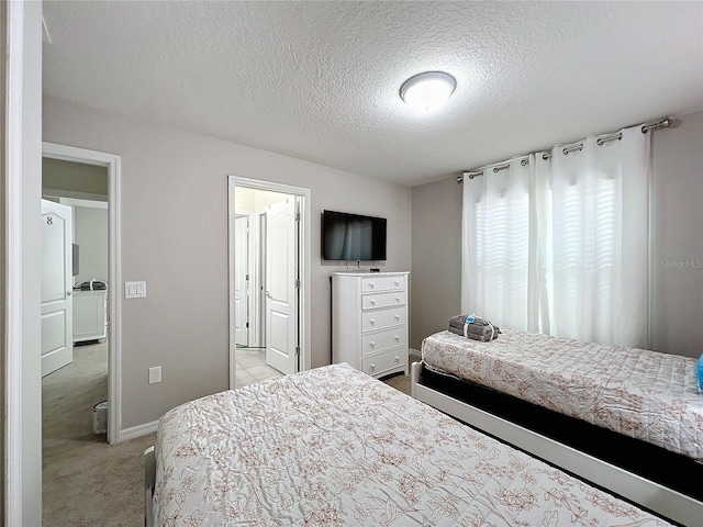 carpeted bedroom featuring a textured ceiling