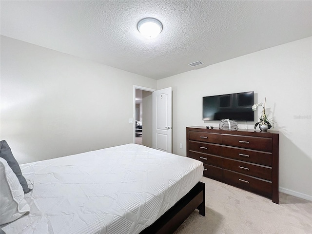 carpeted bedroom featuring a textured ceiling