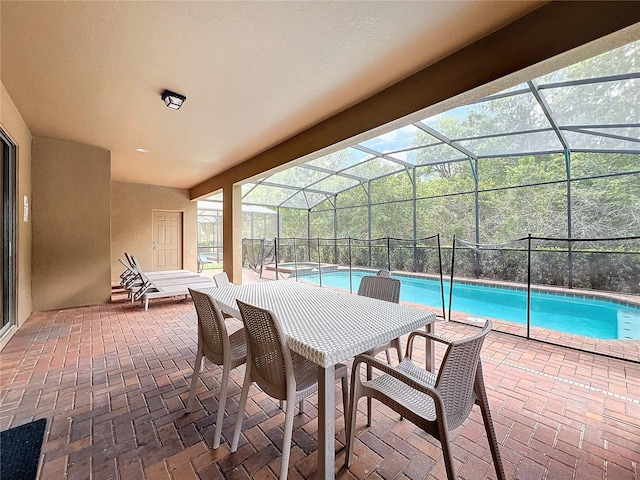 view of pool featuring a lanai, a jacuzzi, and a patio area