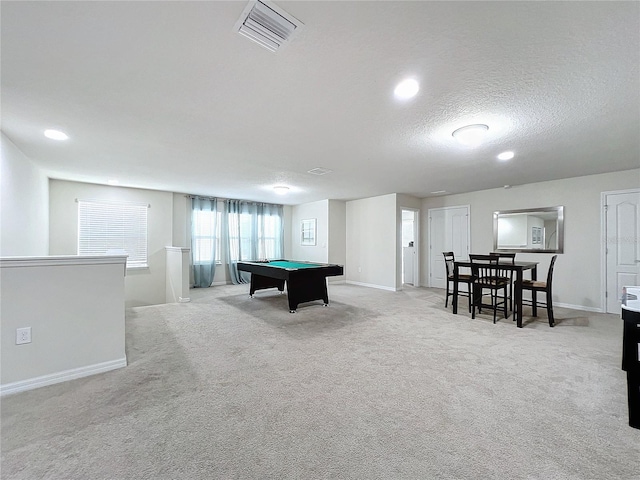 game room featuring billiards, light colored carpet, and a textured ceiling