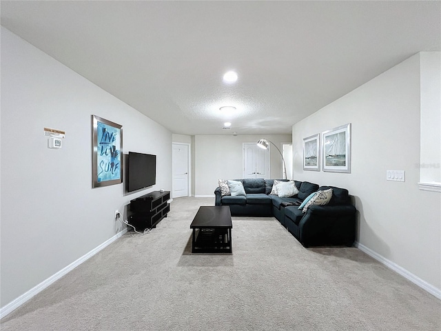 carpeted living room featuring a textured ceiling