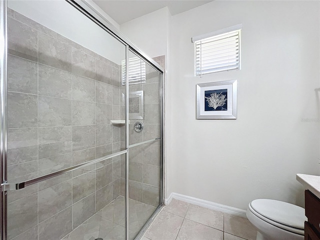 bathroom featuring vanity, an enclosed shower, tile patterned flooring, and toilet