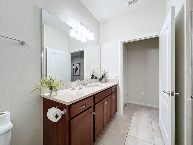 bathroom featuring tile patterned flooring, vanity, and toilet