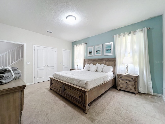 carpeted bedroom with a textured ceiling