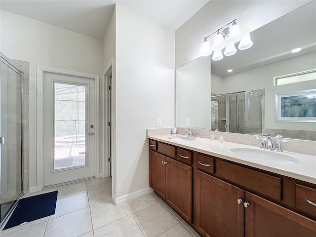 bathroom featuring walk in shower, vanity, and tile patterned flooring