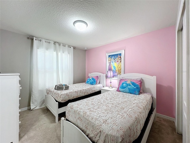 bedroom featuring light carpet and a textured ceiling