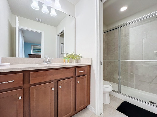 bathroom with tile patterned flooring, vanity, an enclosed shower, and toilet