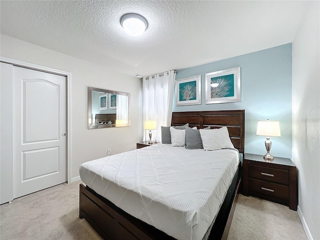 carpeted bedroom with a textured ceiling