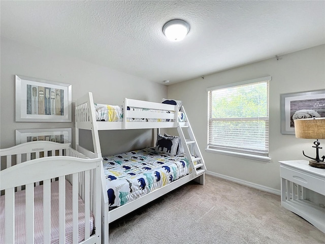 carpeted bedroom featuring a textured ceiling