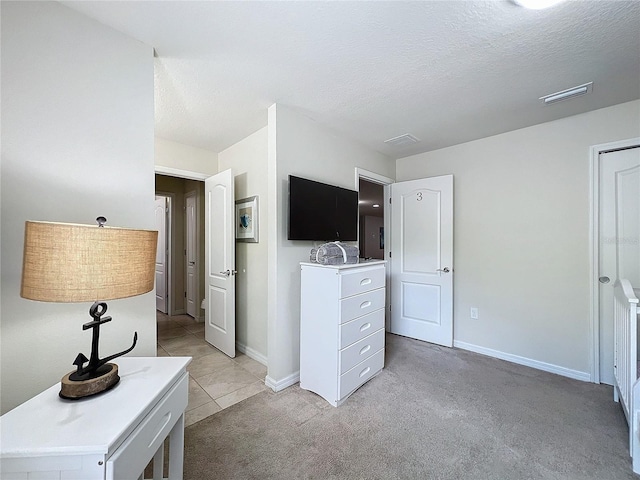 carpeted bedroom featuring a textured ceiling