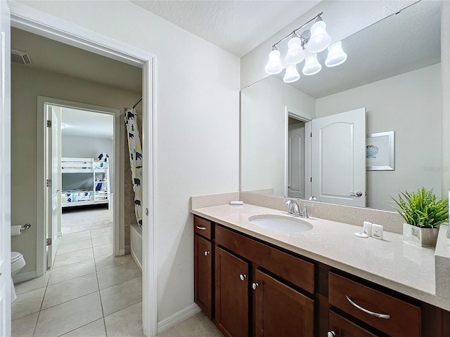 full bathroom featuring vanity, toilet, shower / bath combo, tile patterned floors, and a textured ceiling