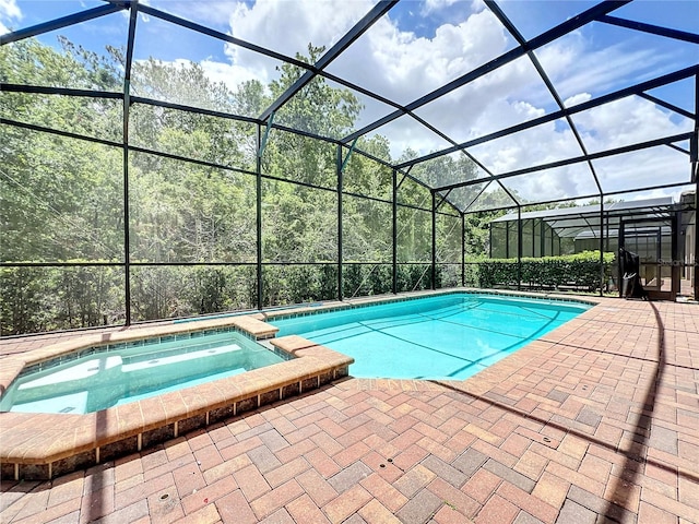 view of swimming pool with an in ground hot tub, a lanai, and a patio area