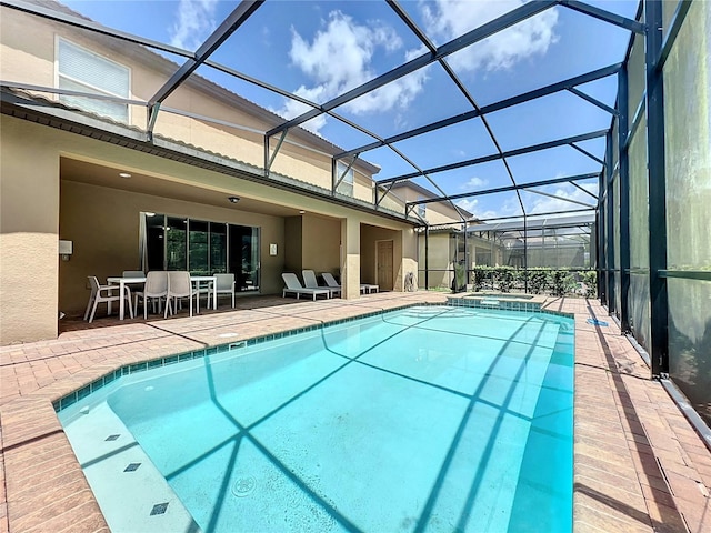 view of pool featuring a patio and glass enclosure