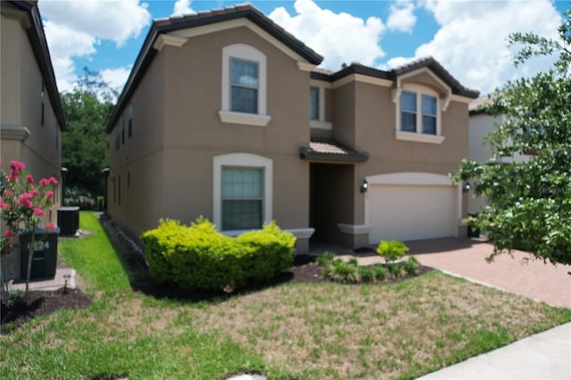 view of front of house with central AC unit, a garage, and a front lawn