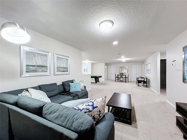 carpeted living room with billiards and a textured ceiling