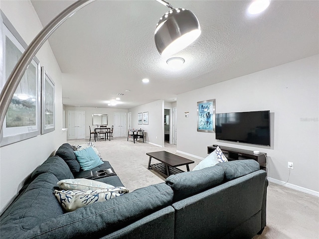 living room with light colored carpet and a textured ceiling