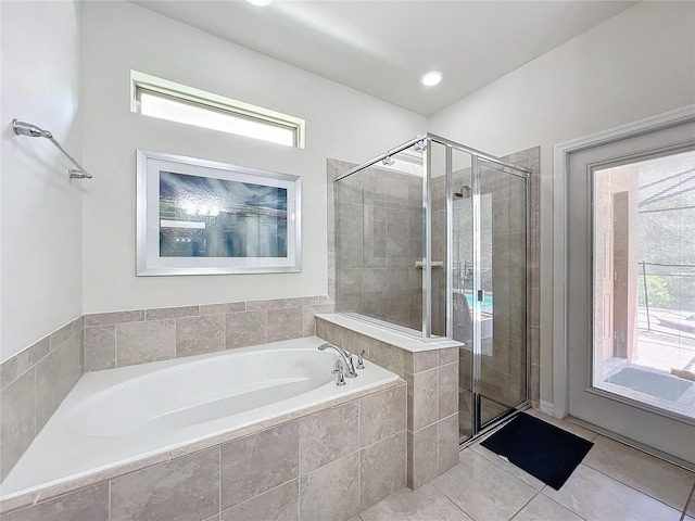 bathroom with tile patterned floors and independent shower and bath