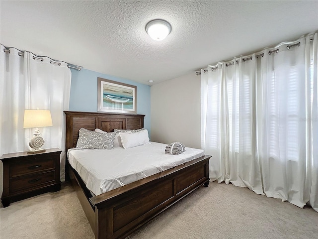 carpeted bedroom featuring a textured ceiling