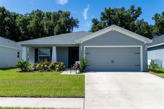 view of front of home featuring a garage and a front lawn