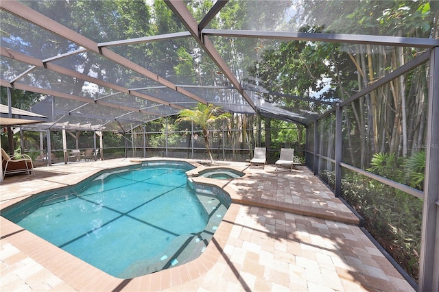 view of swimming pool with glass enclosure, an in ground hot tub, and a patio