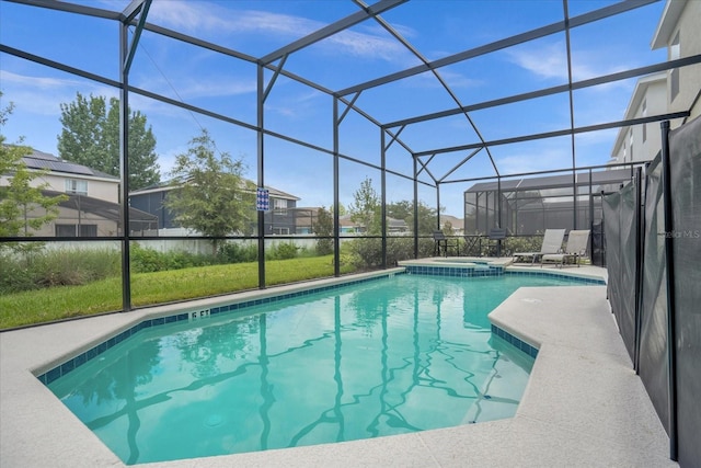 view of swimming pool with a lanai, a patio, and an in ground hot tub