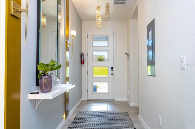 doorway with light tile patterned flooring