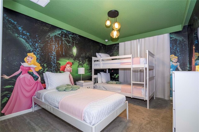 bedroom with carpet floors and a textured ceiling