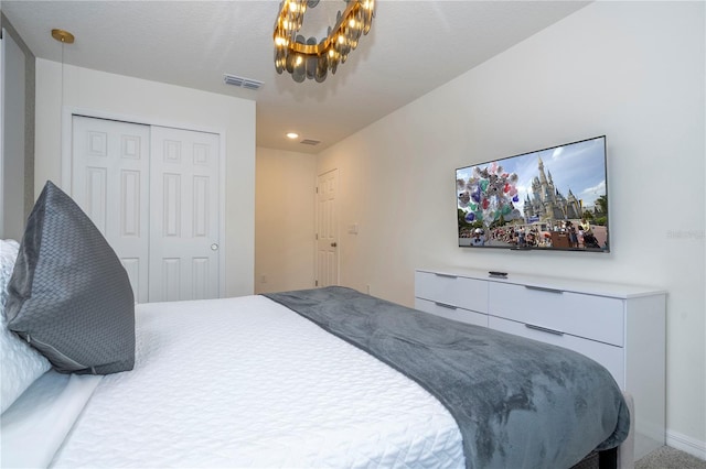 bedroom featuring a notable chandelier and a closet