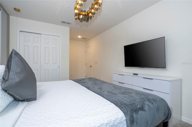 bedroom featuring a closet and a chandelier