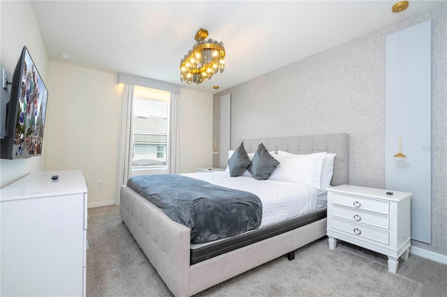 bedroom with a notable chandelier and carpet floors