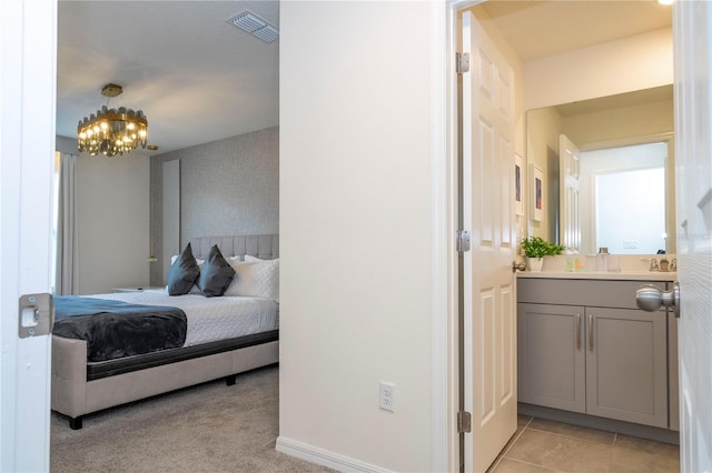 tiled bedroom with a chandelier