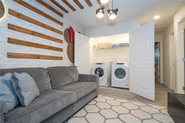 washroom featuring light colored carpet and washer and clothes dryer