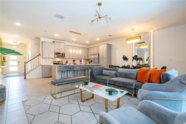 living room with a notable chandelier and light tile patterned floors