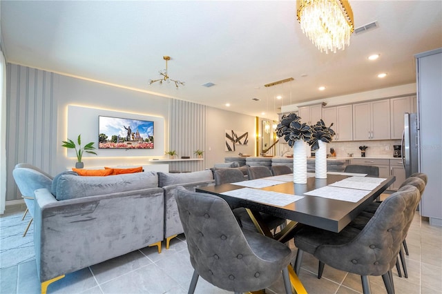 dining room with an inviting chandelier and light tile patterned floors