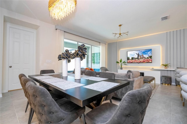 dining area with light tile patterned floors and a chandelier