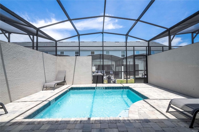 view of pool with a patio and a lanai