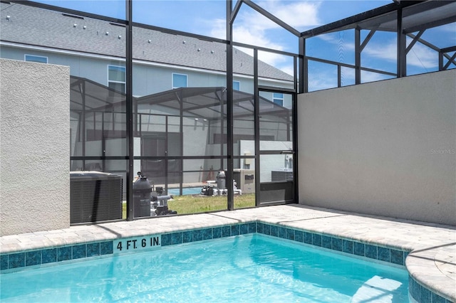 view of swimming pool with central AC and a lanai