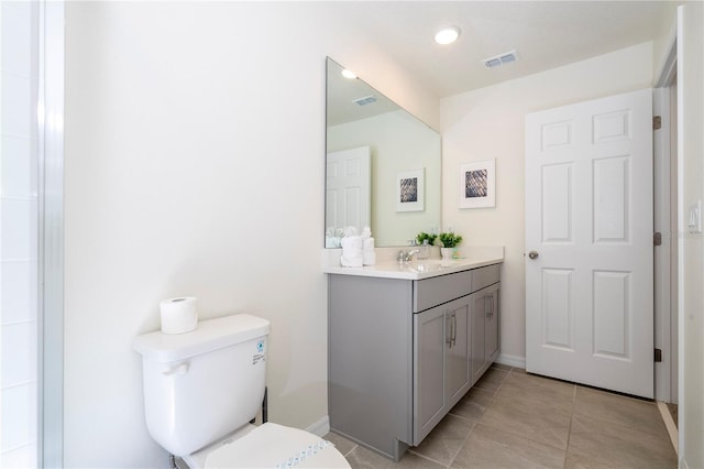 bathroom featuring vanity, tile patterned floors, and toilet