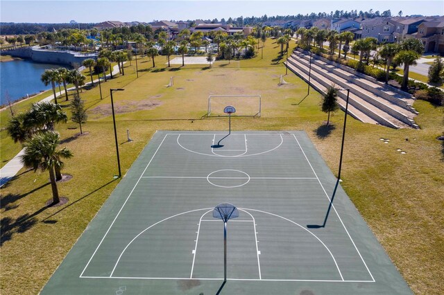 view of sport court featuring a lawn