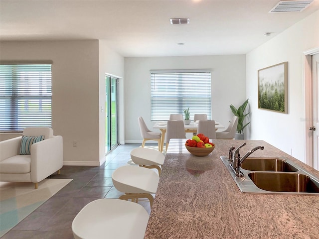 kitchen featuring sink and dark tile patterned flooring