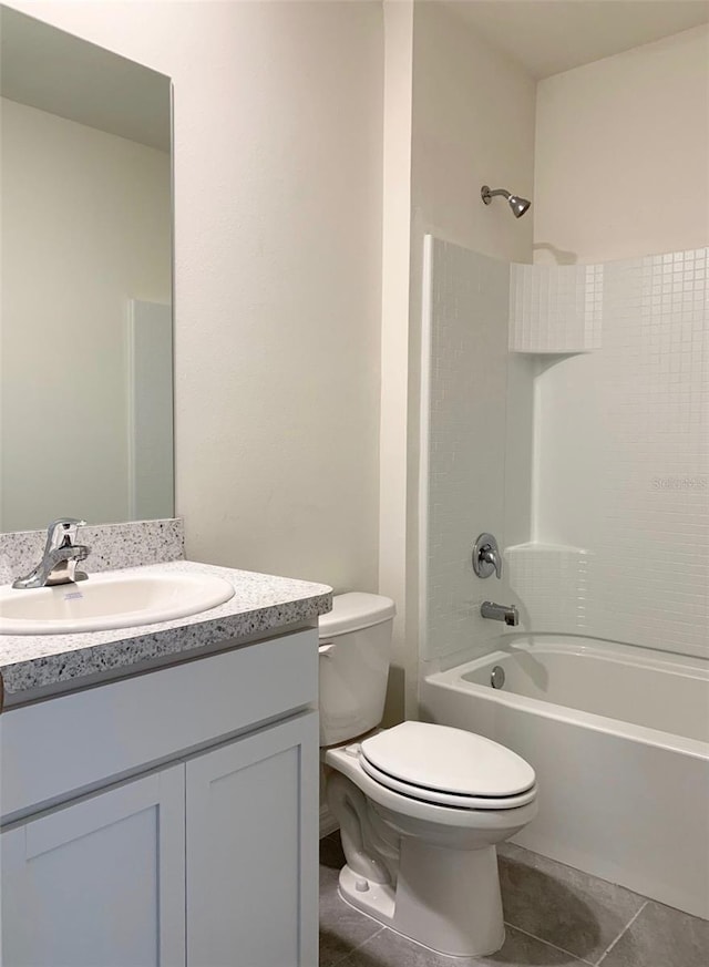 full bathroom featuring bathing tub / shower combination, toilet, tile patterned flooring, and vanity