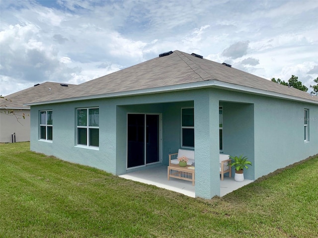 rear view of house featuring a patio and a yard