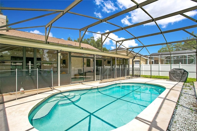 view of pool featuring a patio and glass enclosure