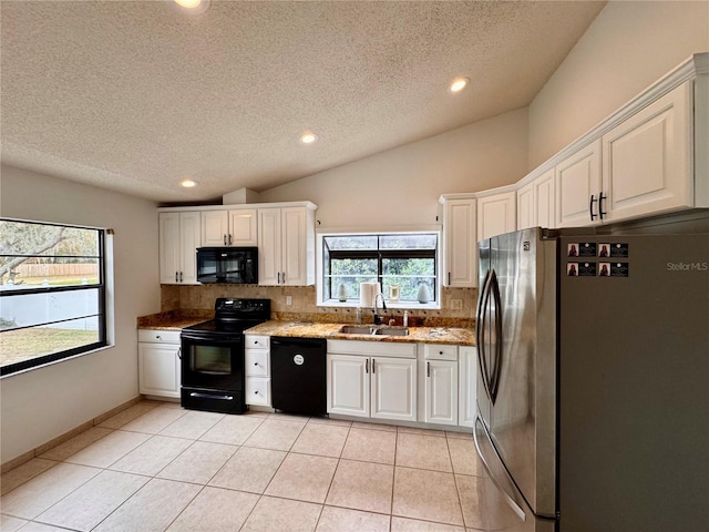 kitchen featuring sink, black appliances, and white cabinets