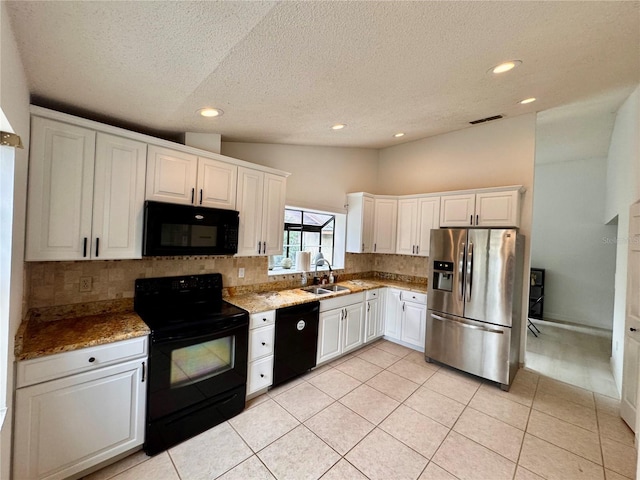 kitchen with backsplash, white cabinets, sink, and black appliances