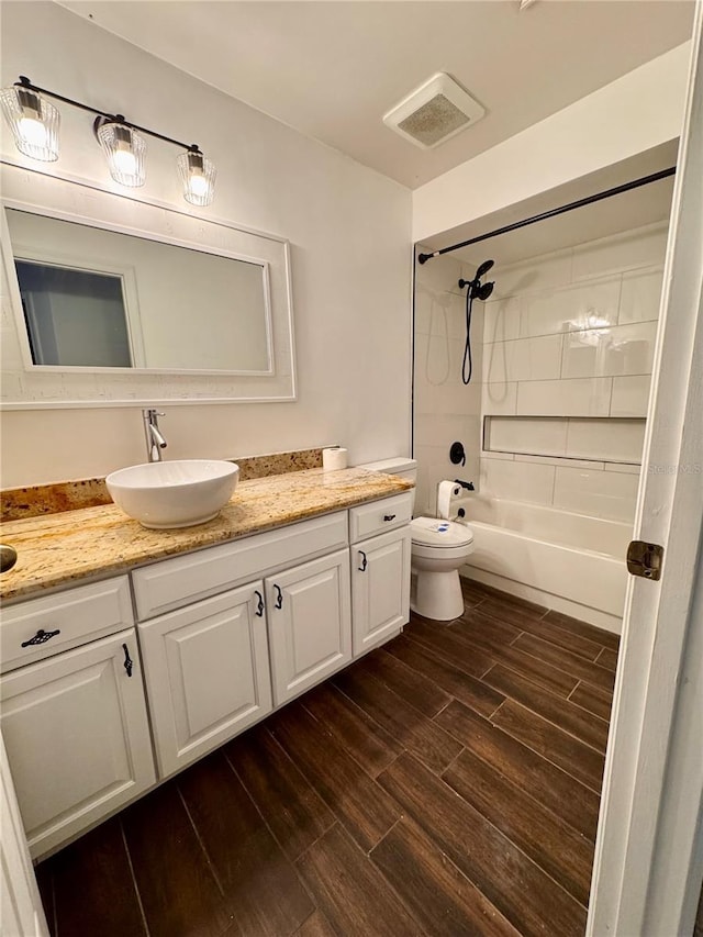 full bathroom featuring shower / bath combination, vanity, and toilet