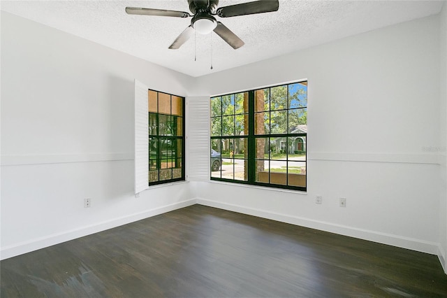 unfurnished room with dark hardwood / wood-style floors, a textured ceiling, and ceiling fan