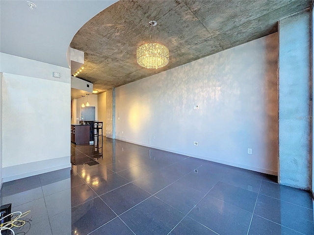 unfurnished room featuring an inviting chandelier